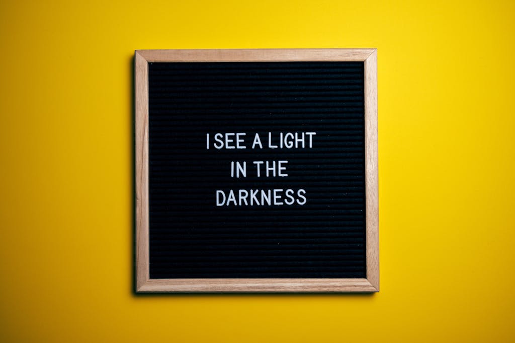 Black letterboard with a motivational quote on a vibrant yellow background.