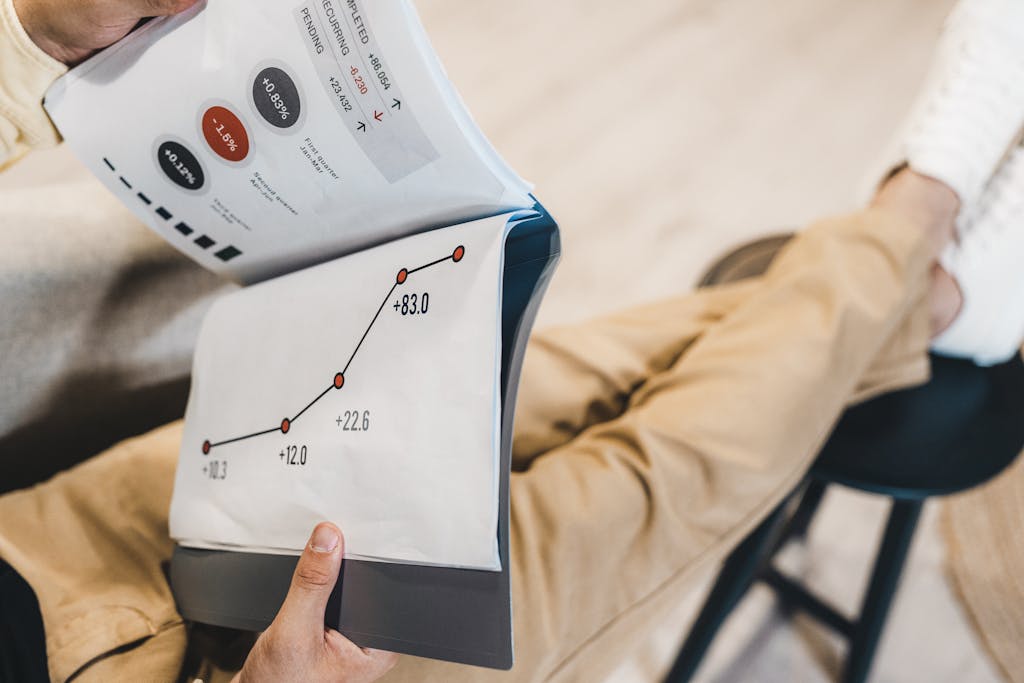 Close-up of a man reviewing business growth charts and statistics in an office setting.