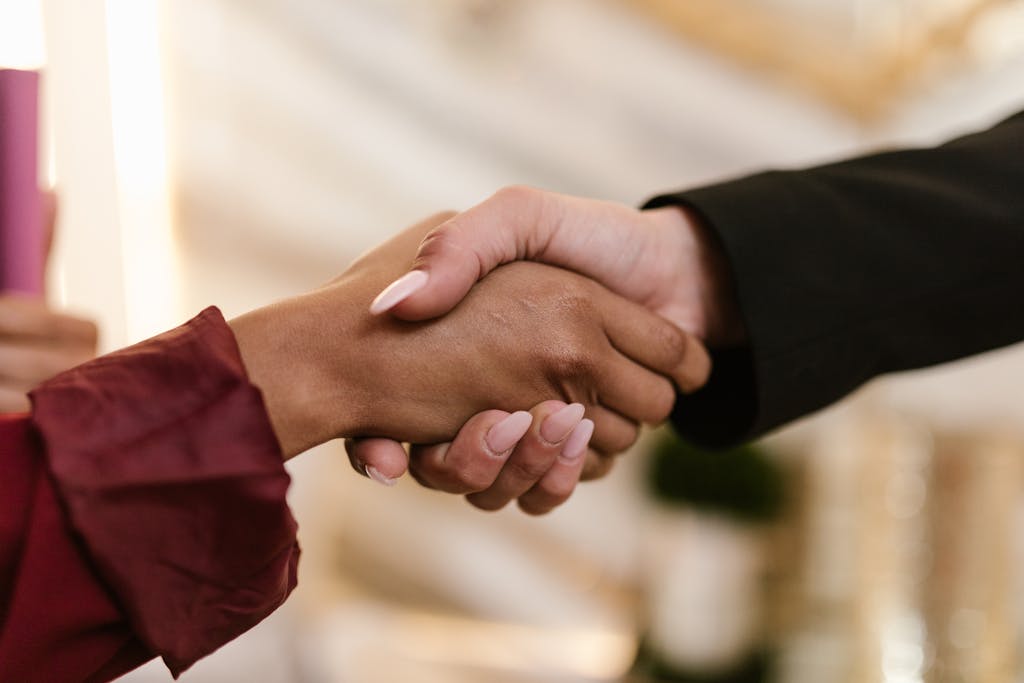 Close-up of two professionals shaking hands, symbolizing agreement and partnership.