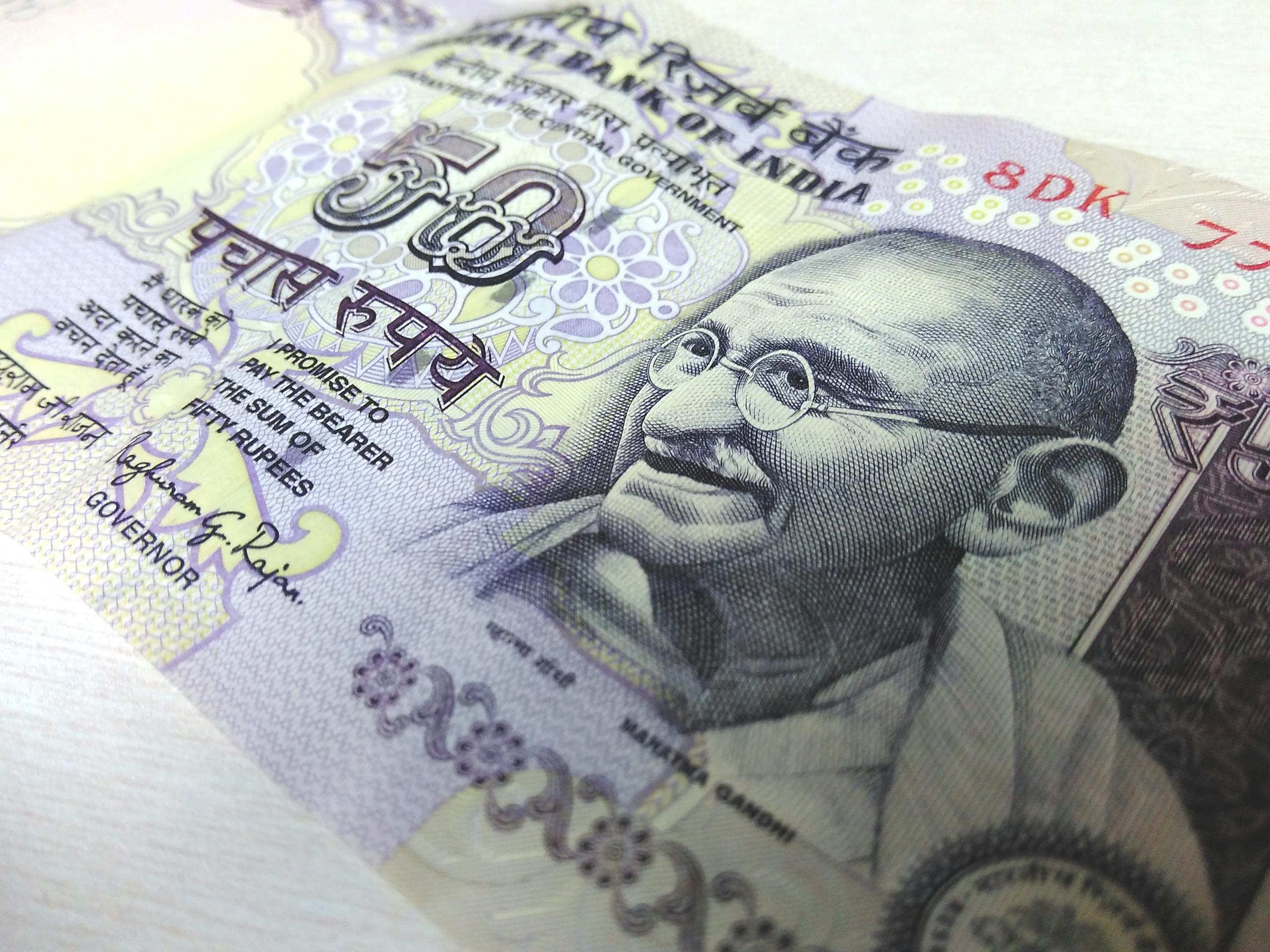 Detailed close-up of an Indian 50 rupee banknote featuring Mahatma Gandhi, highlighting security features.