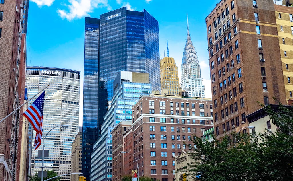 Stunning view of Midtown Manhattan skyscrapers including the Chrysler Building under a blue sky.