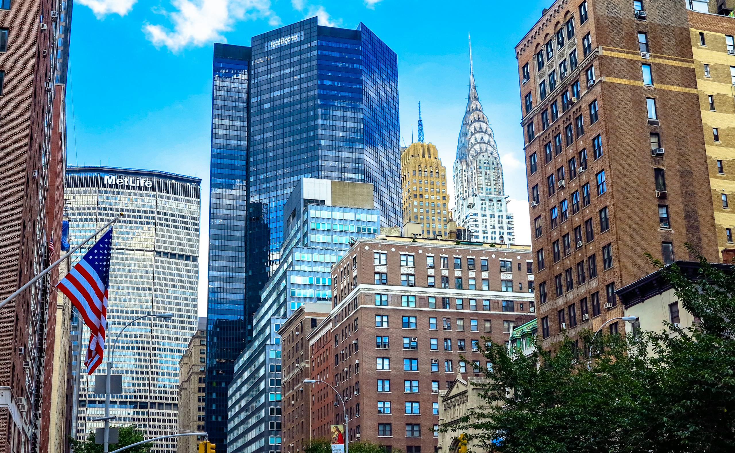 Stunning view of Midtown Manhattan skyscrapers including the Chrysler Building under a blue sky.