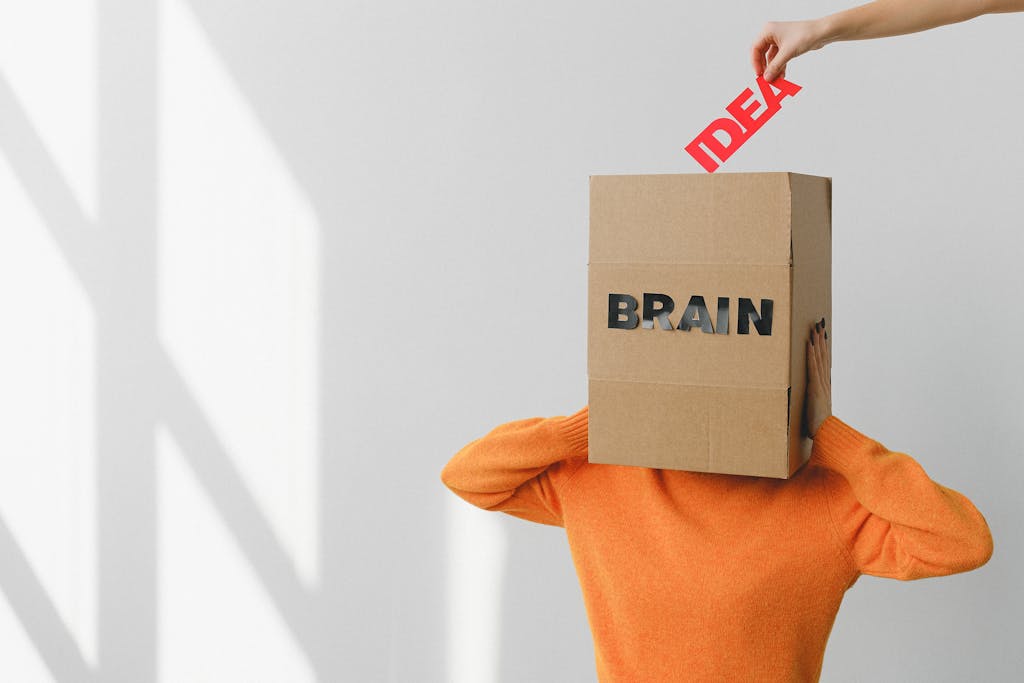 Surreal image of a person with a cardboard brain, symbolizing idea and intellect.