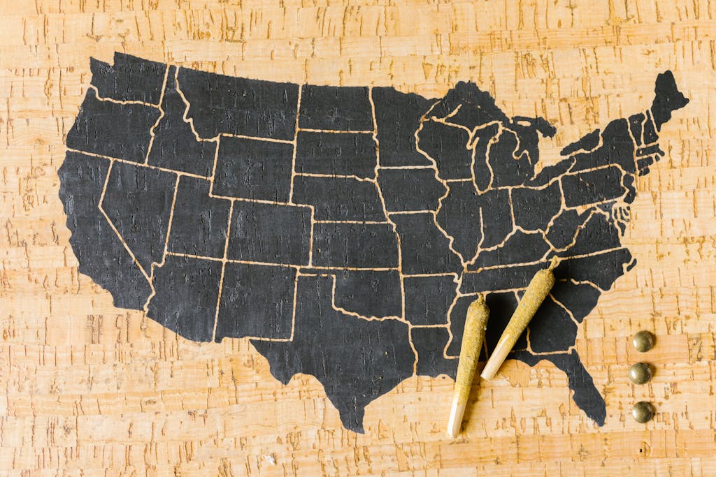 Two cannabis joints placed over a USA map, symbolizing marijuana legalization.